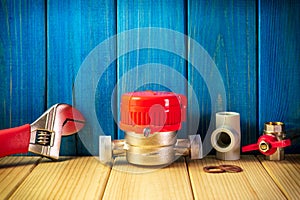 New water meter with fittings on a blue wooden background