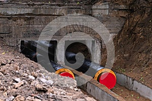 New water pipes being laid down deep into the ground. Construction site, main water line in the ditch