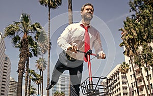 A new way of scooting around. Happy guy ride electric scooter on street. Scooting e-scooter photo