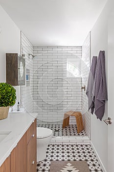 New well appointed bathroom with white tiles and checkerboardtile