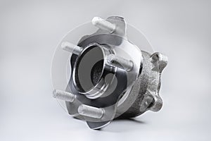 New Wheel hub assembly with bearing. This is part of the car suspension on a gray background with a gradient. The