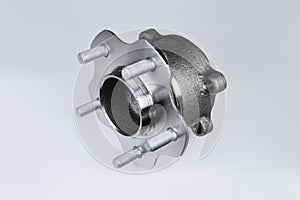 New Wheel hub assembly with bearing. This is part of the car suspension on a gray background with a gradient. The