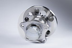 New Wheel hub assembly with bearing. This is part of the car suspension on a gray background with a gradient. The