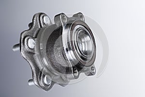 New Wheel hub assembly with bearing. This is part of the car suspension on a gray background with a gradient. The