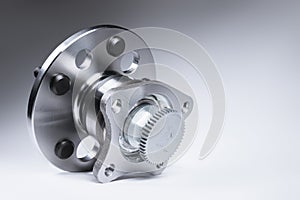 New Wheel hub assembly with bearing. This is part of the car suspension on a gray background with a gradient. The