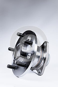 New Wheel hub assembly with bearing. This is part of the car suspension on a gray background with a gradient. The