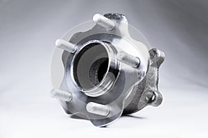 New Wheel hub assembly with bearing. This is part of the car suspension on a gray background with a gradient. The