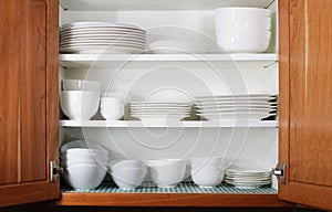 New White Dishes and Bowls in Kitchen Cabinet