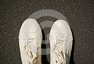 New white gym plimsolls on the pavement