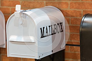 New white mailbox on brick wall