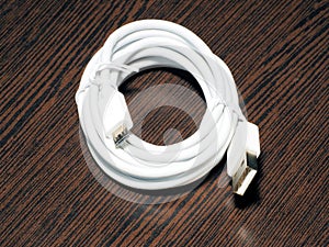 New white usb cable on wooden background