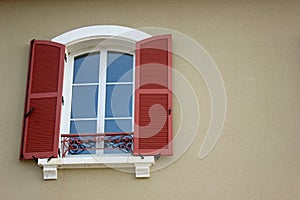 New window with red shutters from an old building