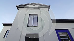 New windows installed on old building facade under blue sky