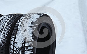 New winter tires on fresh snow, closeup.