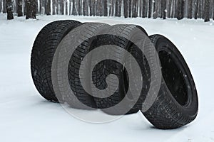 New winter tires on snow near forest