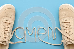 Women sneakers with laces in omen text. photo