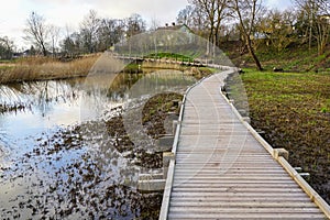 New wooden footpath for walk in nature park photo