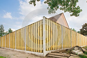 New wooden fence at garden of house