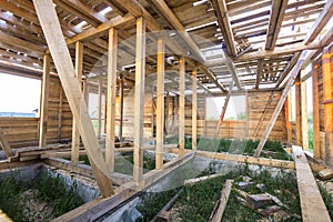 New wooden house under construction. Close-up of walls and ceiling frame with windows openings from inside. Ecological dream home