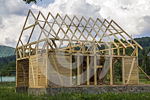 New wooden house under construction in quiet rural neighborhood.