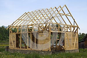 New wooden house under construction in quiet rural neighborhood.