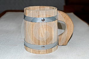 New wooden mug on the table in the bath