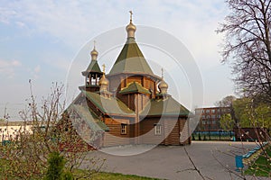 New wooden Orthodox church, dome with a cross and blue sky. Russia