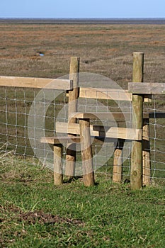 New wooden stile over wire fence in countryside