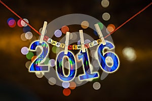 New Year 2016 concept clipped cards on christmas lights background.