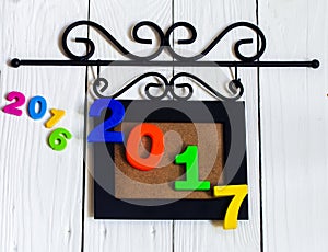 New year 2017, the figures in the picture frame on white wooden background