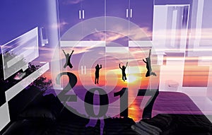 New Year 2017 with silhouette family jumping on the mountain.