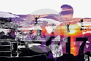 New Year 2017 with silhouette family jumping on the mountain and man background.