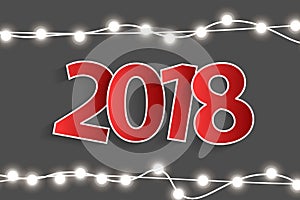 New Year 2018 concept with red paper cuted white numbers on realistic Christmas lights decorations on grey background