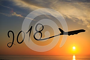 New year 2018 drawing by airplane on the air at sunrise