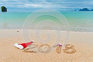 New year 2018 holiday vacation concept, 2018 written on tropical beach sand