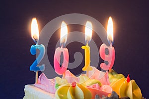 New Year 2019. Burning festive candles on cake close-up