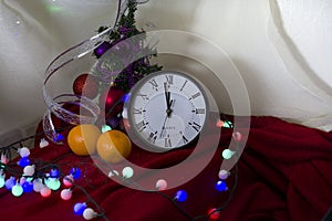 New Year 2020. Christmas decoration clock and toys on a dark background with lights. Background for design