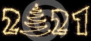 New Year 2021 with Christmas tree made by sparkler . Number 2021 and sign written sparkling sparklers . Isolated on a black