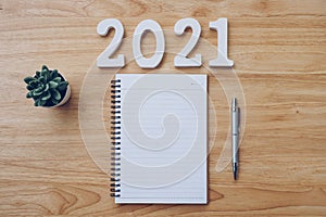 New year 2021 list. Office desk table with notebooks and pancil with pot plant