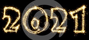 New Year 2021 made by sparkler . Number 2021 written sparkling sparklers . Isolated on a black background . Overlay template for