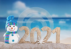 New year 2021 sign with snowman on beach background