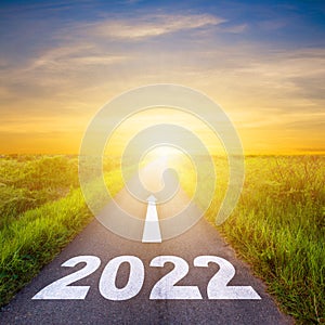 New Year 2022 Goals Concept : Empty asphalt road sunrise with text go to New year 2022