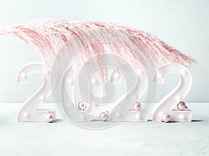 New year 2022 lights numbers with pink pampas branch, ornaments