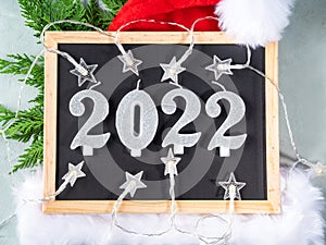 New year 2022 numbers on blackboard with star shape lights