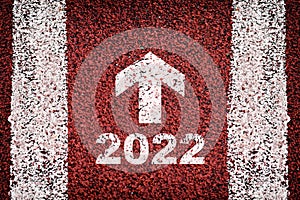 New year 2022 and white arrow on road surface with marking lines