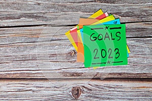 New year 2023 goals, resolutions and bucket list concept. Colorful sticky notes on wood