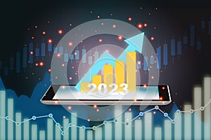 New year 2023 growth graphs return on investment on smartphone with currency symbol on abstract background