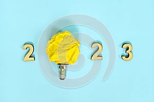 New year 2023 innovation, creativity in business ideas concept. 2023 text with bright yellow light bulb.