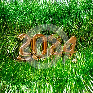 New Year 2024 - Orange old gold numbers on light green glitter grass background