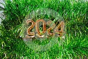 New Year 2024 - Orange old gold numbers on light green glitter grass background